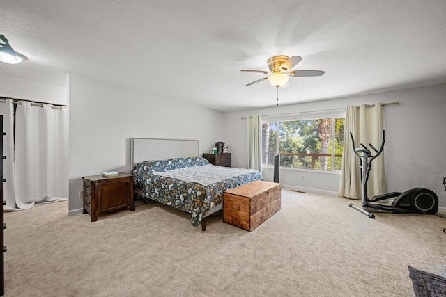 carpeted bedroom featuring visible vents, baseboards, and a ceiling fan