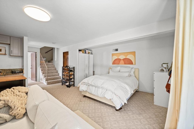 bedroom with light carpet and visible vents