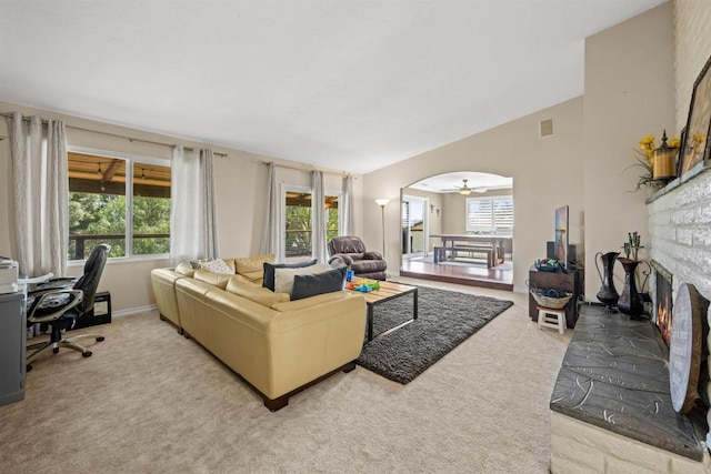 carpeted living room with a ceiling fan and plenty of natural light