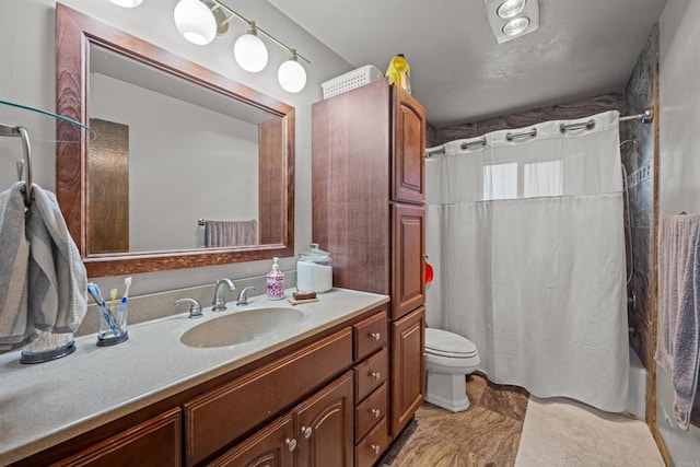 full bath featuring vanity and toilet