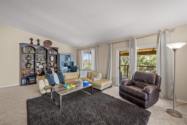 carpeted living room with baseboards and vaulted ceiling
