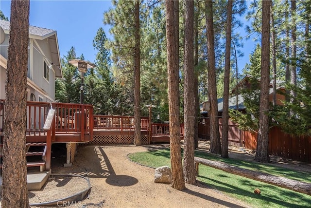 view of yard featuring fence and a deck