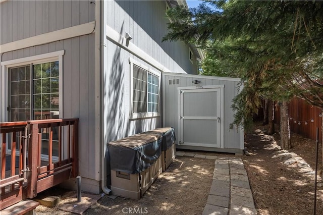 view of shed featuring fence
