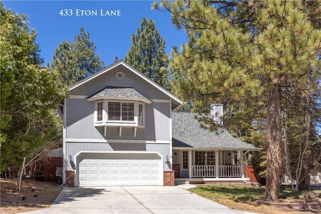 view of front of house with an attached garage, a shingled roof, a porch, and driveway