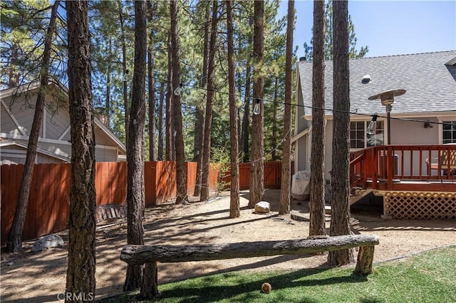 view of yard with fence and a deck