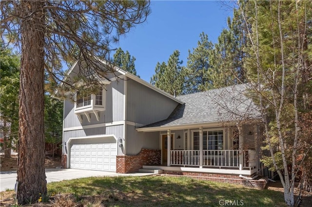split level home featuring driveway, a porch, a garage, brick siding, and roof with shingles