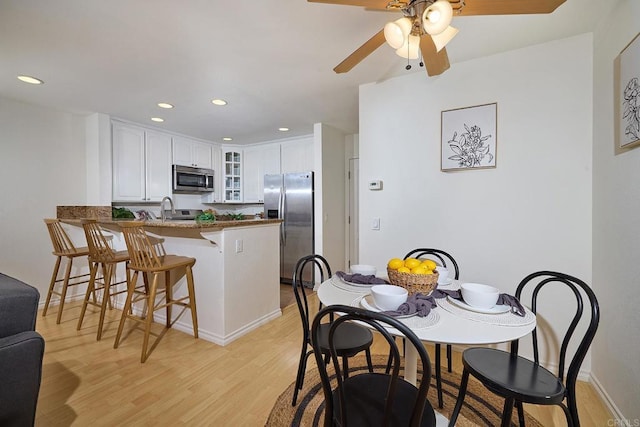dining room featuring recessed lighting, ceiling fan, and light wood finished floors