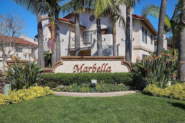 community sign featuring a lawn