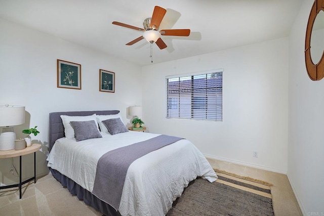 bedroom with baseboards, ceiling fan, and carpet
