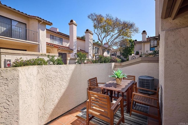 view of patio / terrace with central AC, a residential view, and fence