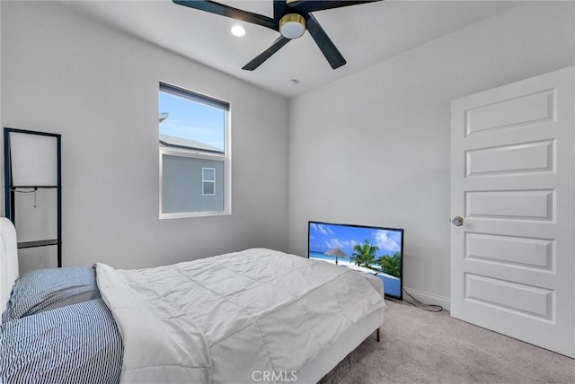 carpeted bedroom featuring ceiling fan and baseboards