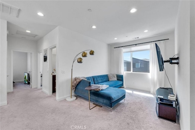 carpeted living area featuring recessed lighting, visible vents, and baseboards