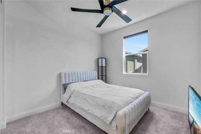 carpeted bedroom featuring baseboards and ceiling fan