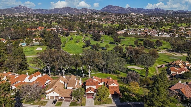 birds eye view of property featuring a mountain view, view of golf course, and a residential view