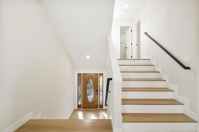 foyer featuring recessed lighting, stairs, baseboards, and wood finished floors