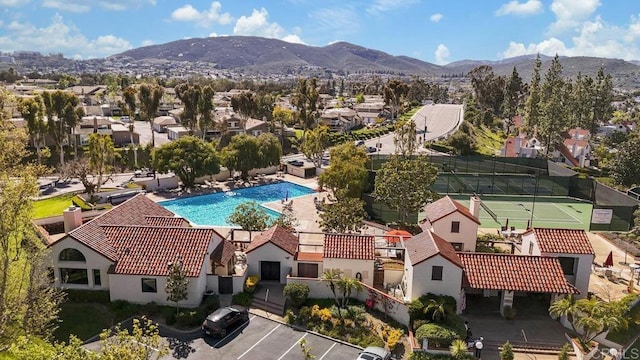 birds eye view of property with a mountain view and a residential view