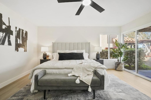 bedroom featuring access to outside, wood finished floors, ceiling fan, and baseboards
