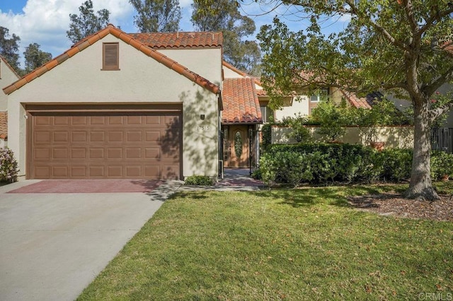 mediterranean / spanish-style home with a tile roof, a garage, driveway, a front yard, and stucco siding