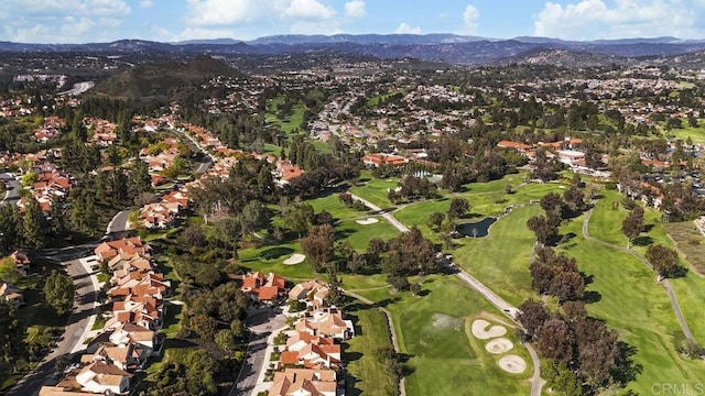 aerial view with view of golf course, a residential view, and a mountain view
