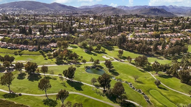 birds eye view of property with golf course view, a water and mountain view, and a residential view