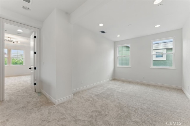 unfurnished room featuring light colored carpet, visible vents, recessed lighting, and baseboards