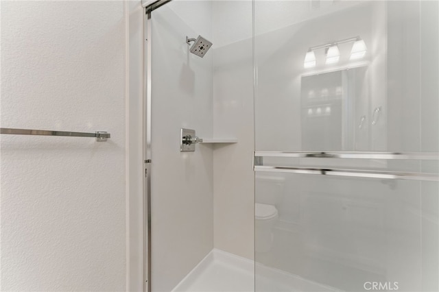 full bath featuring toilet and a walk in shower