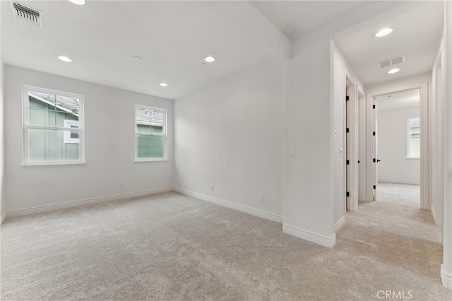 unfurnished room featuring recessed lighting, carpet flooring, baseboards, and visible vents