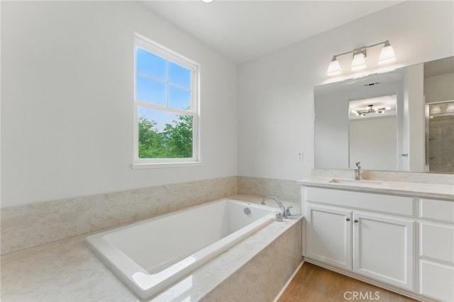 full bath featuring vanity and a bath