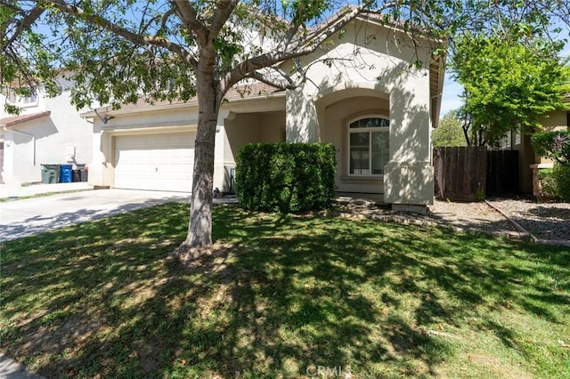 view of front of house featuring an attached garage, fence, stucco siding, a front lawn, and driveway