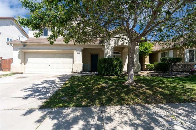 view of front of home with concrete driveway, a front lawn, a tile roof, and stucco siding