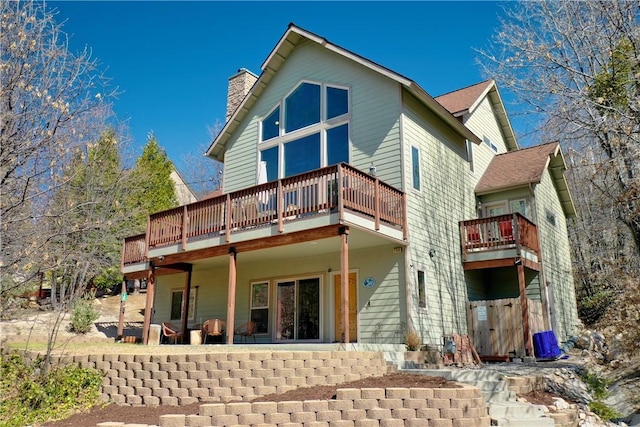 756 Brentwood Dr, Lake Arrowhead, CA 92352 - back of property with a chimney and a wooden deck