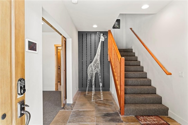 stairway with baseboards and recessed lighting
