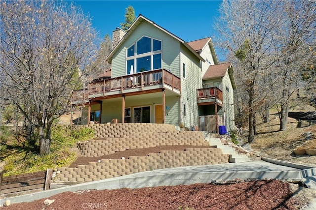 756 Brentwood Dr, Lake Arrowhead, CA 92352 - view of front of house with a wooden deck and a chimney