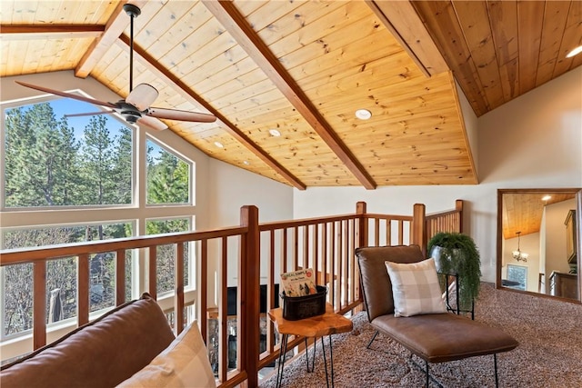 sitting room with a ceiling fan, wood ceiling, beam ceiling, high vaulted ceiling, and carpet flooring