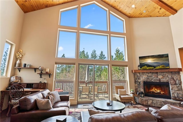 living room with wood ceiling, a high ceiling, and wood finished floors