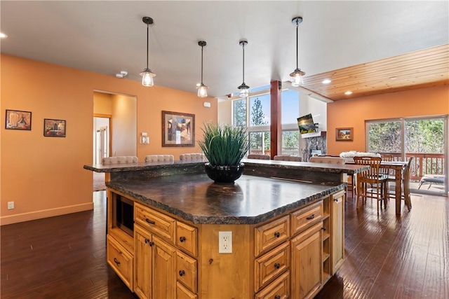 756 Brentwood Dr, Lake Arrowhead, CA 92352 - kitchen featuring dark wood-style floors, dark countertops, recessed lighting, brown cabinetry, and hanging light fixtures