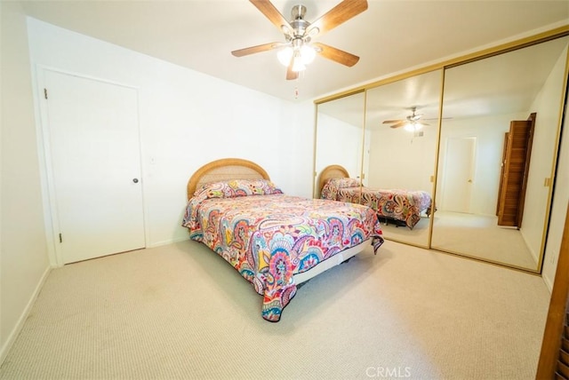 bedroom featuring a closet, carpet flooring, baseboards, and a ceiling fan
