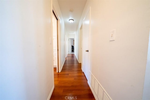 corridor with wood finished floors and visible vents