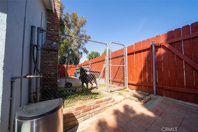 view of patio / terrace featuring fence and a gate