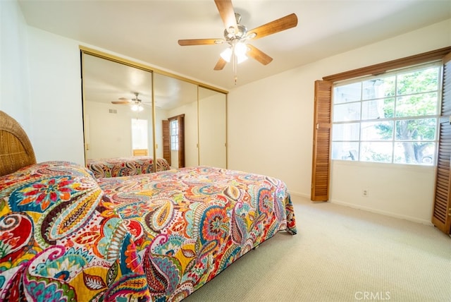bedroom with a closet, baseboards, multiple windows, and carpet