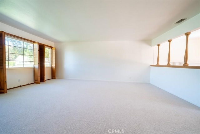 unfurnished room with light carpet and visible vents