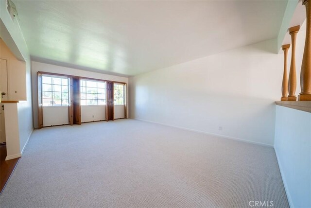 carpeted spare room with baseboards