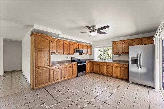 10806 Bayonne Dr, Riverside, CA 92505 - kitchen with light tile patterned floors, a ceiling fan, brown cabinetry, stainless steel appliances, and a sink
