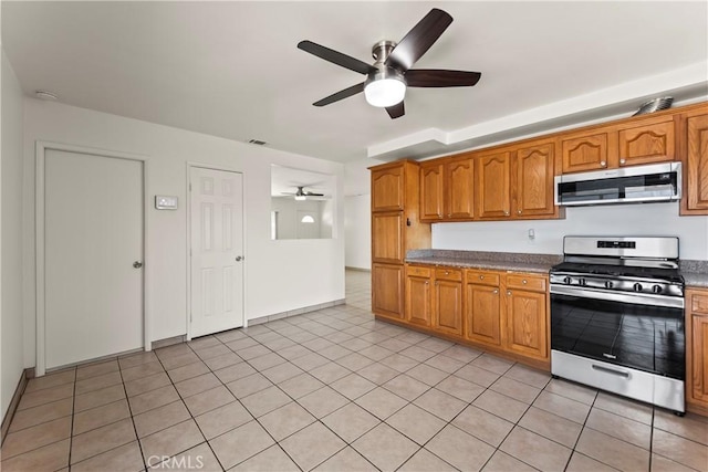 10806 Bayonne Dr, Riverside, CA 92505 - kitchen featuring visible vents, light tile patterned floors, a ceiling fan, brown cabinets, and stainless steel appliances
