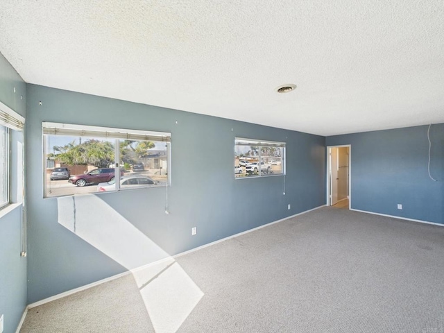 837 Oneonta St, Imperial Beach, CA 91932 - empty room with a textured ceiling, carpet, and plenty of natural light