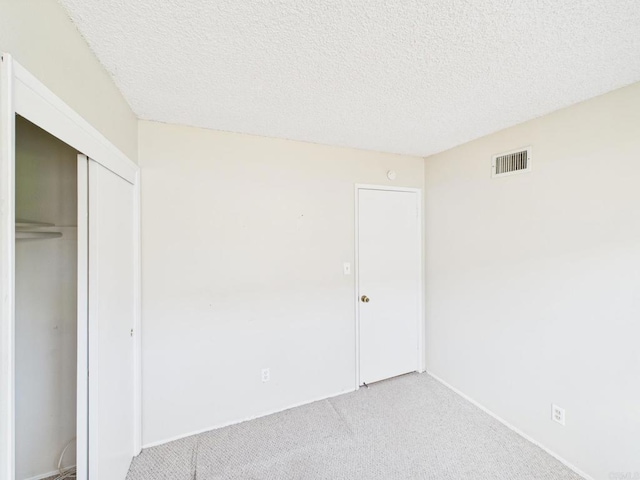 837 Oneonta St, Imperial Beach, CA 91932 - unfurnished bedroom featuring a closet, visible vents, light colored carpet, and a textured ceiling