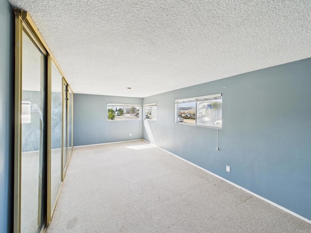 837 Oneonta St, Imperial Beach, CA 91932 - unfurnished room featuring a textured ceiling, baseboards, and carpet floors