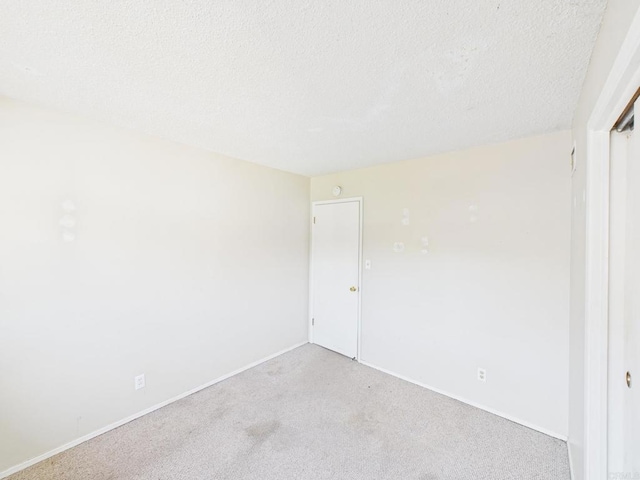 837 Oneonta St, Imperial Beach, CA 91932 - unfurnished room with light carpet, a textured ceiling, and baseboards