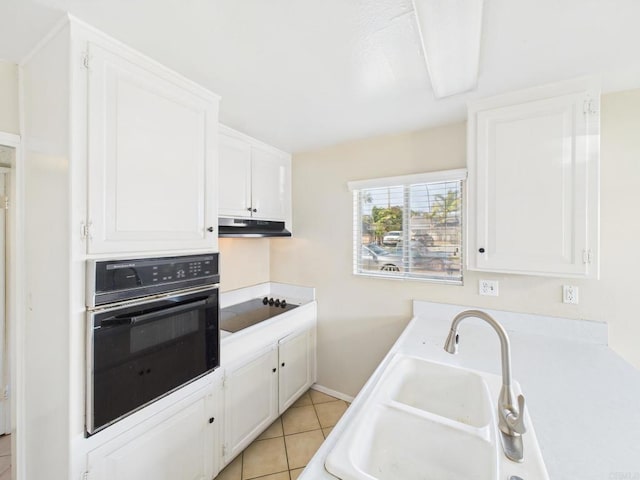 837 Oneonta St, Imperial Beach, CA 91932 - kitchen with white cabinets, under cabinet range hood, a sink, and black appliances
