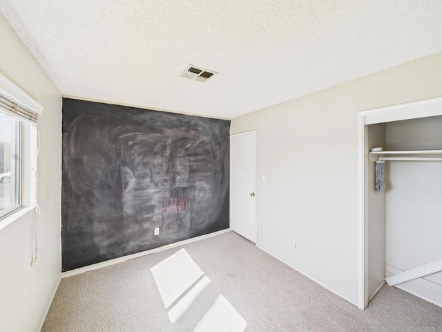 837 Oneonta St, Imperial Beach, CA 91932 - unfurnished bedroom featuring a closet, visible vents, a textured ceiling, and carpet floors